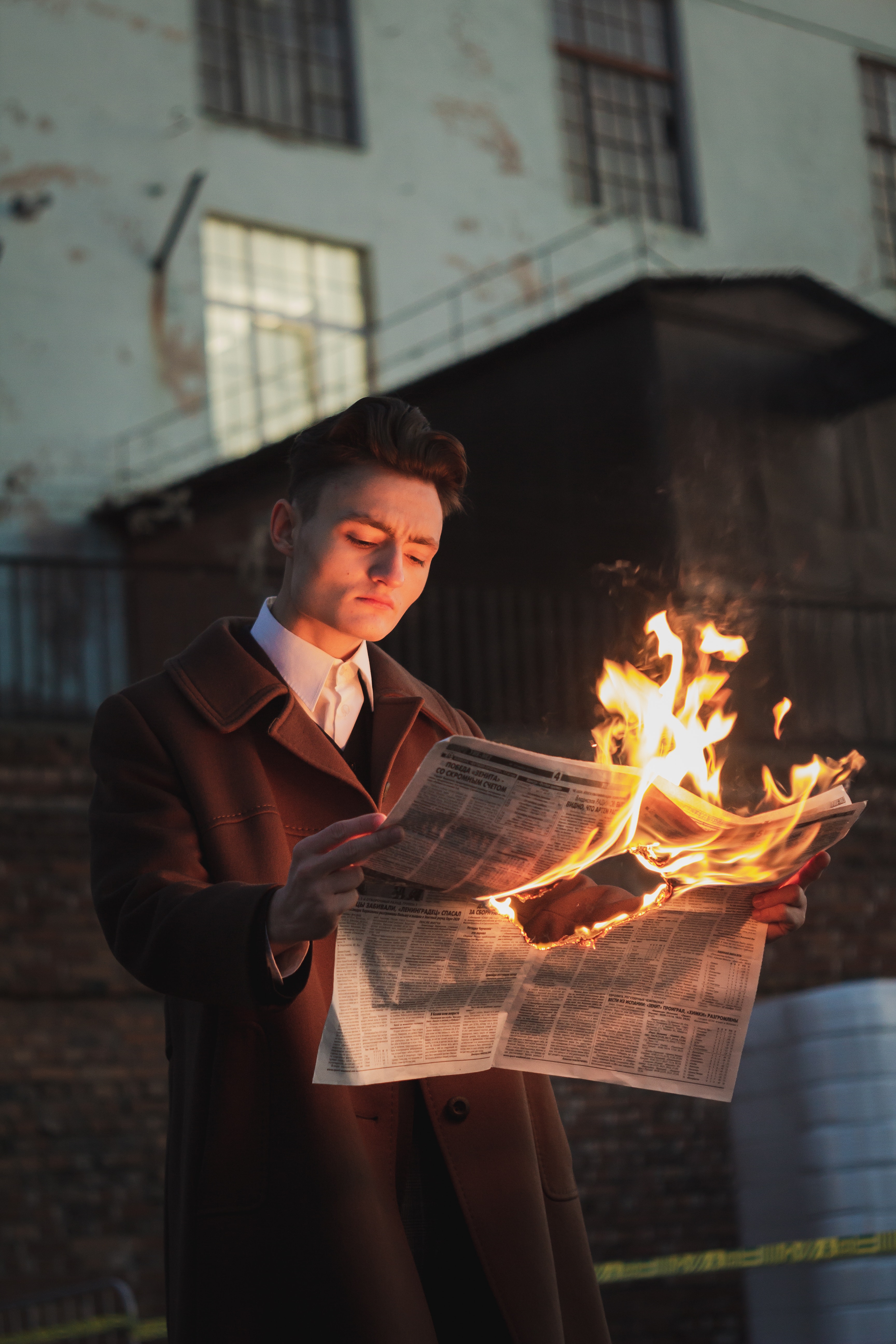 Photograph: "Man Reading Burning Newspaper" by Danya Gutan.